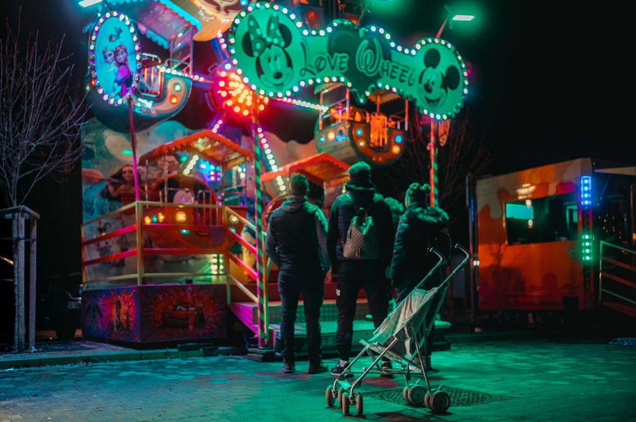 An empty stroller standing in front of a kids attraction.