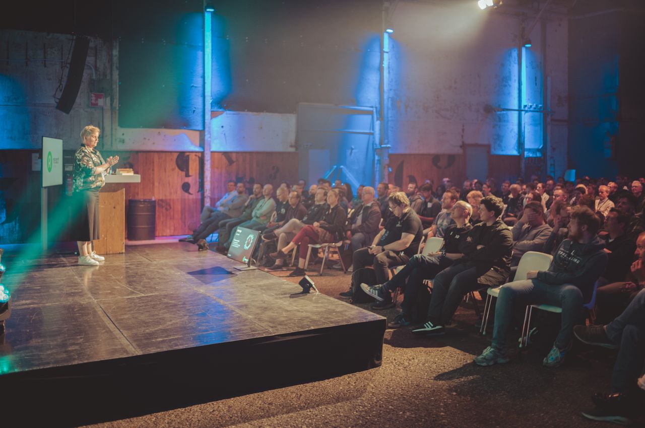 A speaker on stage addressing the audience.