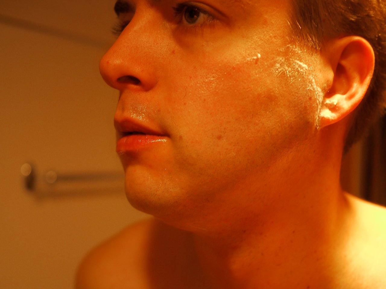 Close-up of a clean-shaven man with shaving cream residue on his face, marking the start of Movember.