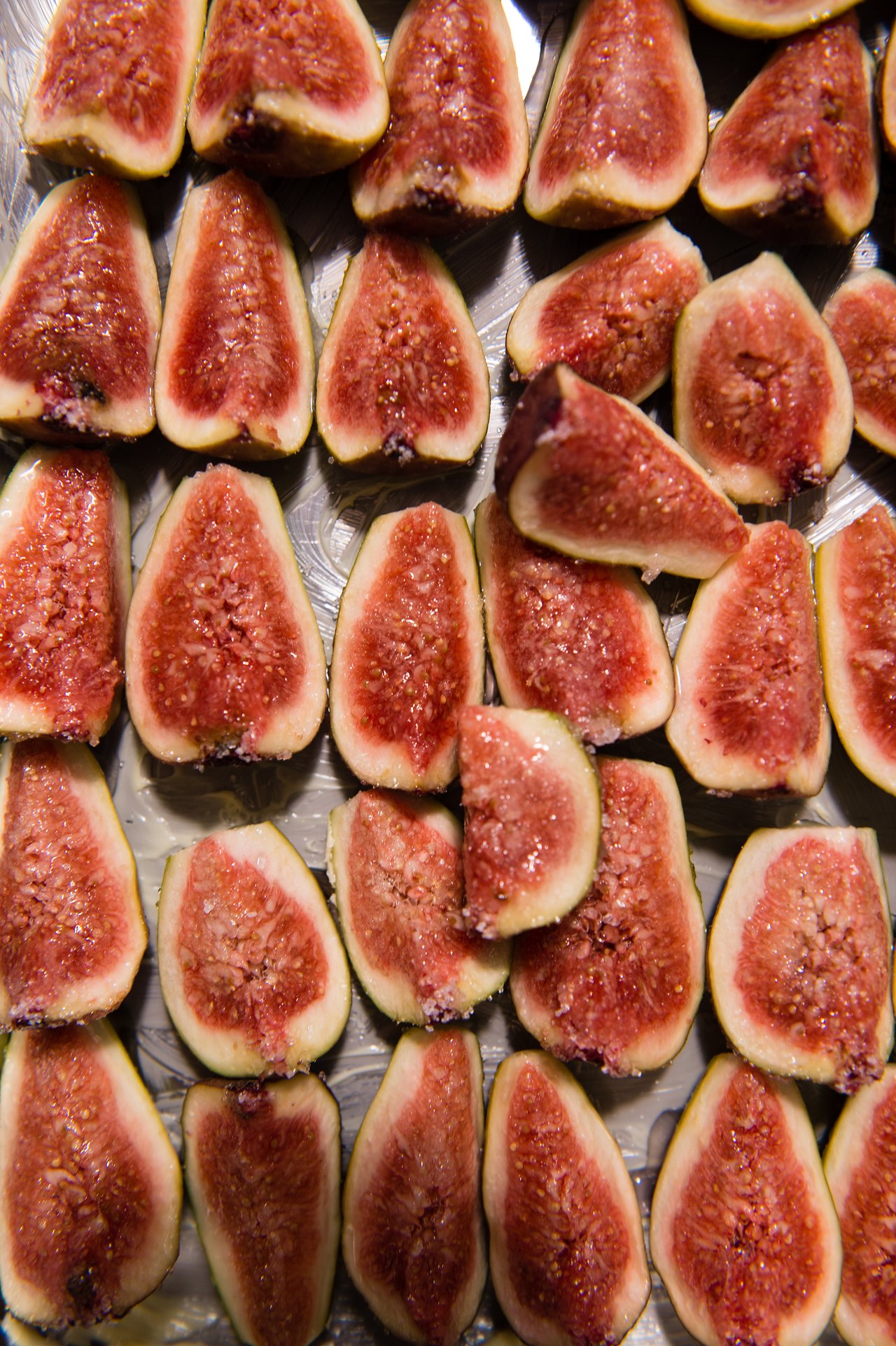A tray filled with freshly sliced figs, arranged neatly for a New Year's Eve party.