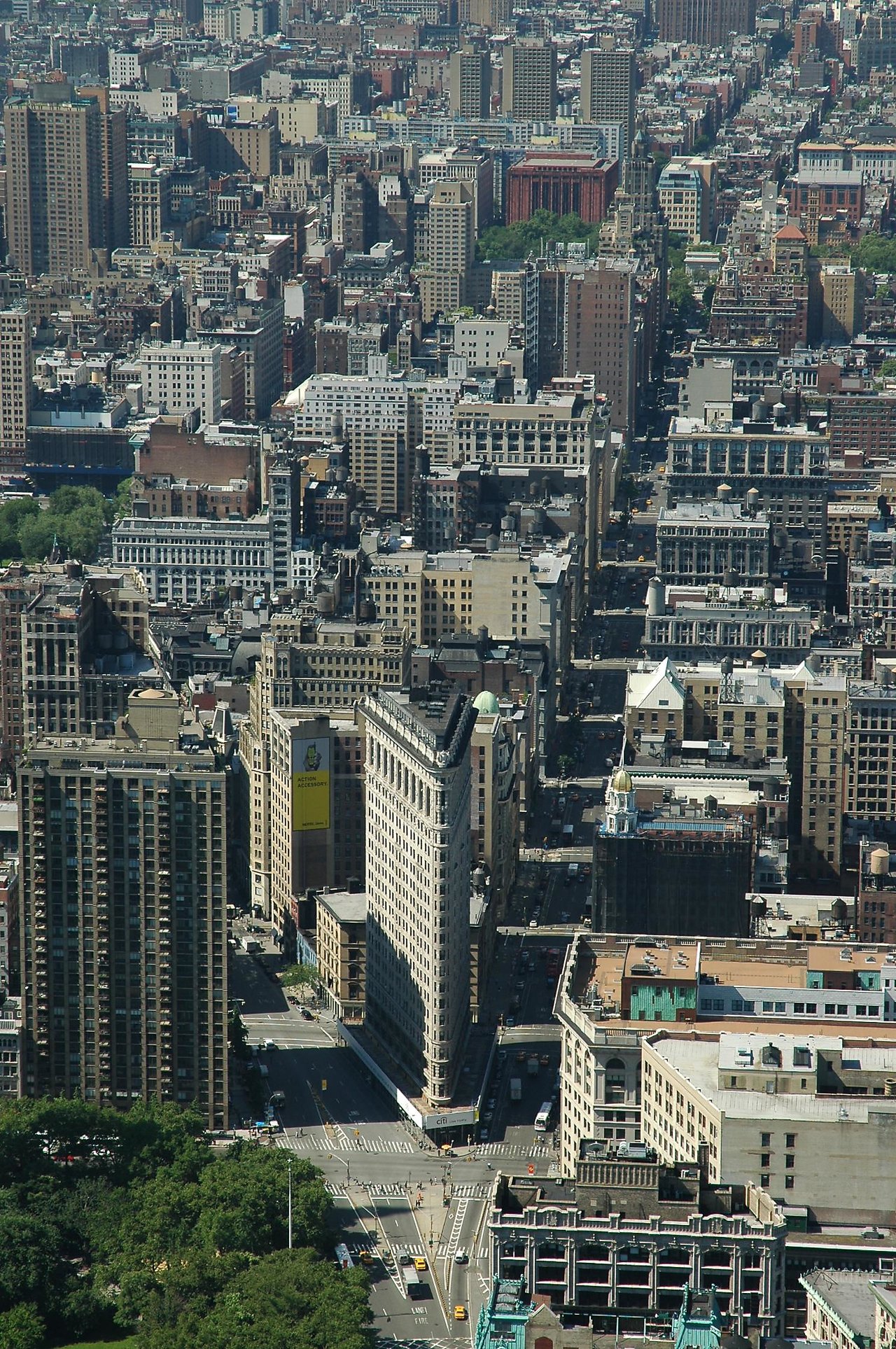 Aerial view of a cityscape with the Flatiron Building at a busy intersection in New York City.