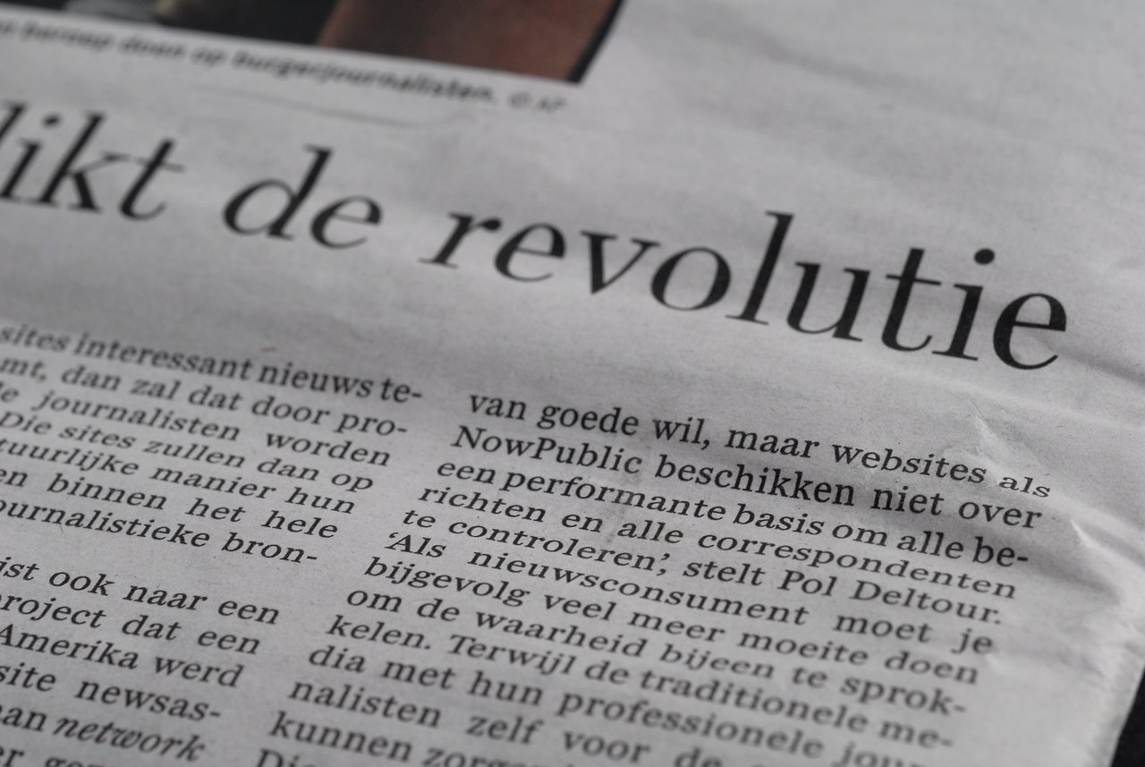 Close-up of a newspaper article discussing the credibility of citizen journalism compared to professional journalism.