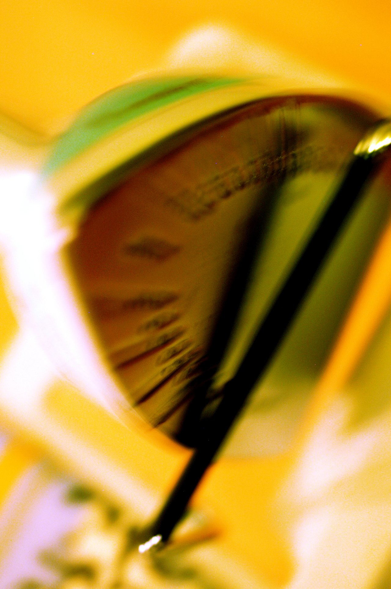 Close-up of an iron with a blurred motion effect, showing its reflective surface and temperature settings.