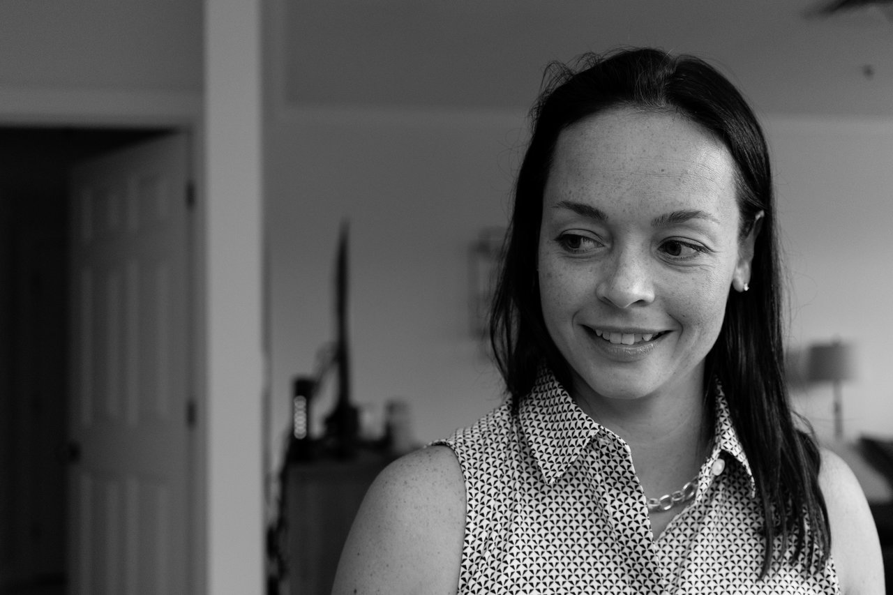 A woman smiles and looks to the side during a Jenga game night.