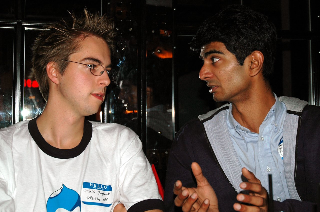 Two people sitting at a table, engaged in conversation.