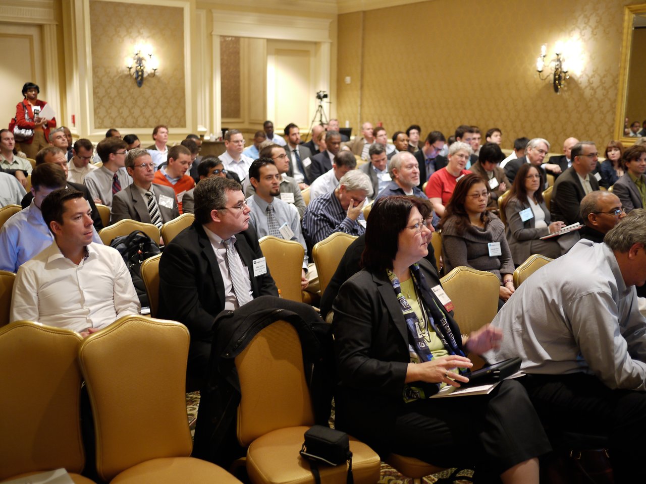 A large audience attentively listens and takes notes during the Drupal Business Summit in Washington, 2010.