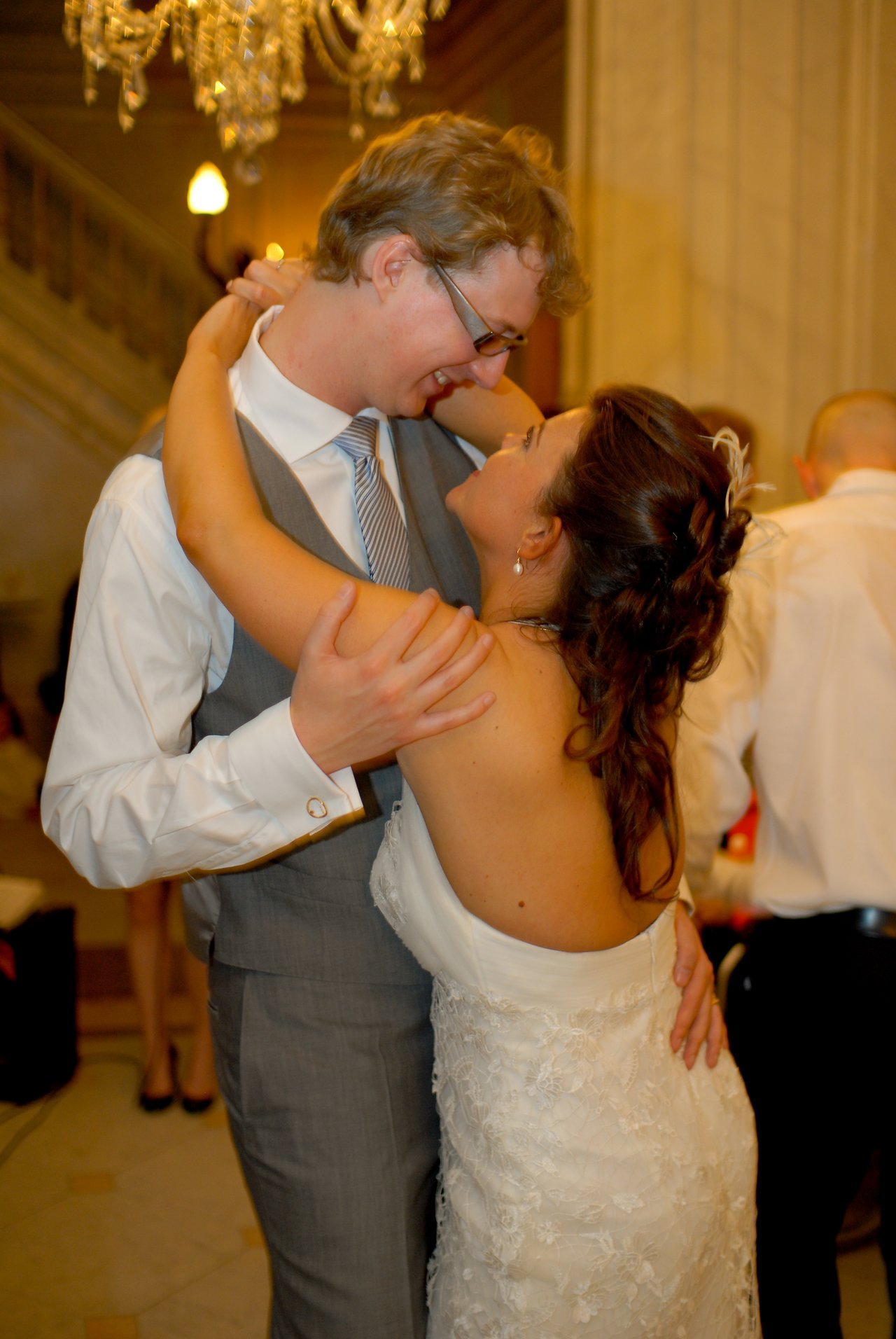 The bride and groom share their opening dance, embracing closely and smiling at each other.