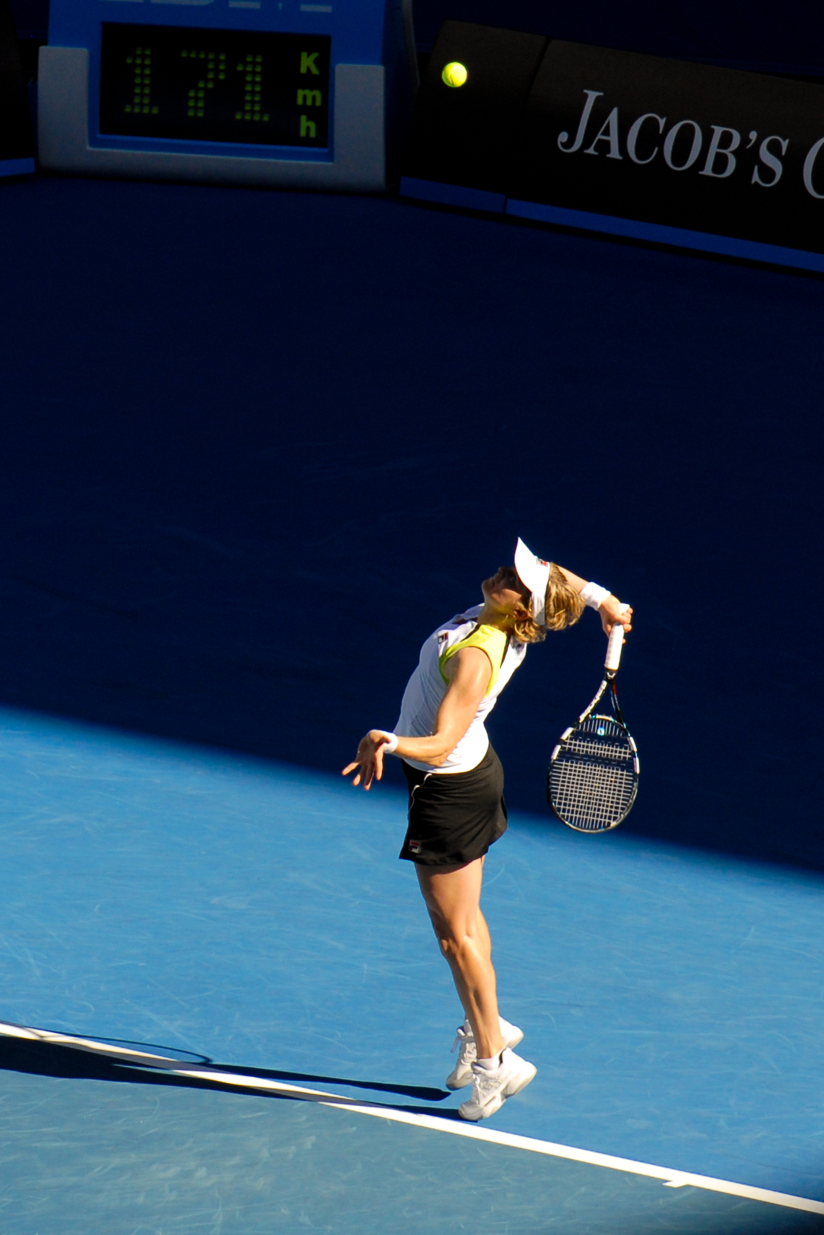A tennis player serves the ball during a match at the Australian Open 2012.