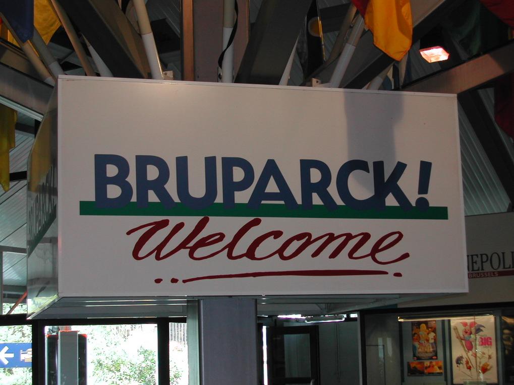 A large sign reads "BRUPARCK! Welcome" in bold letters, hanging indoors with flags and lights above it.