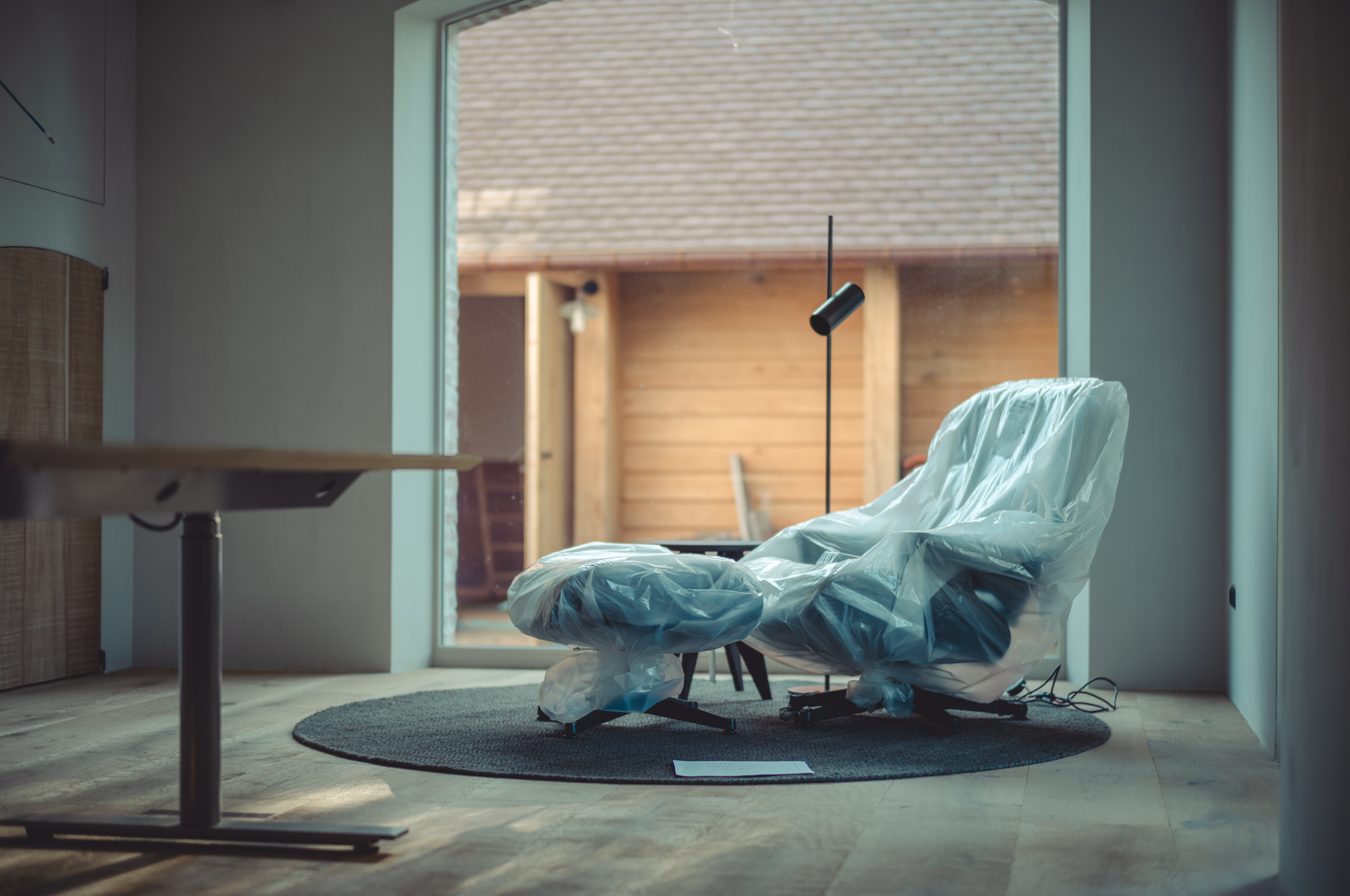 A plastic-wrapped lounge chair.