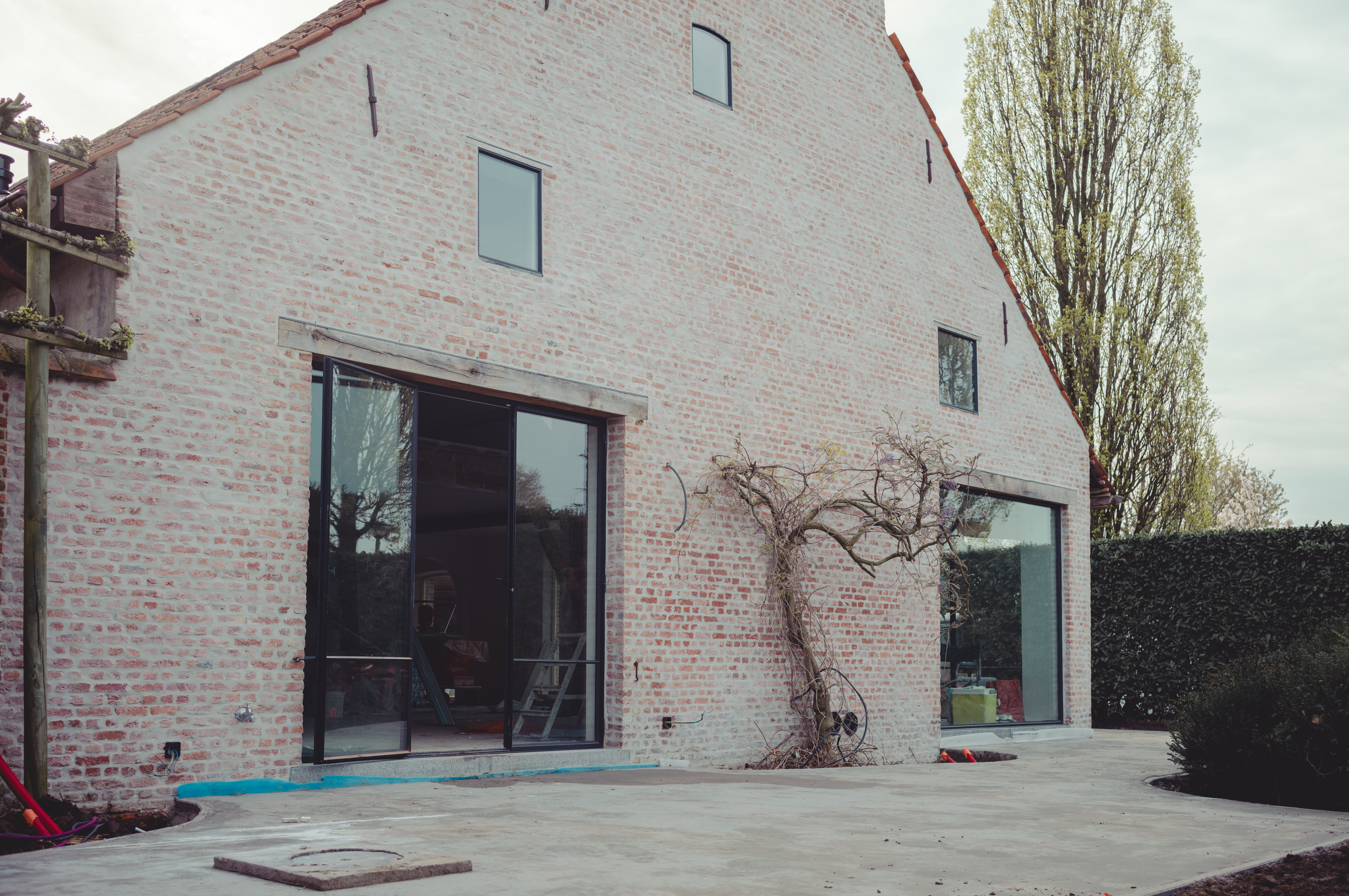 A brick house with a concrete terrace foundation.