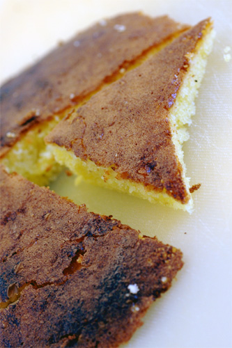 A close up of a triangular piece of cake