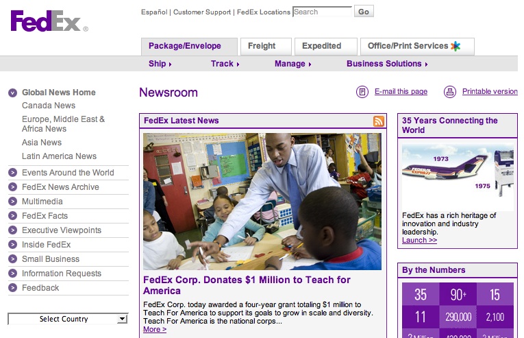 A teacher in a classroom helps young students with a learning activity, as part of a FedEx donation program.