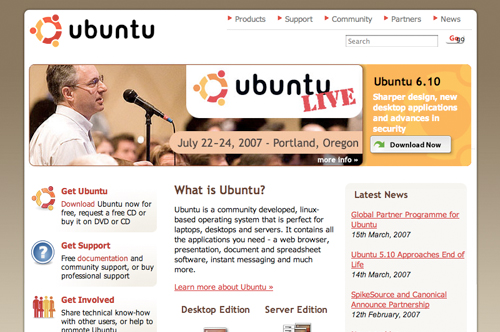 A man speaks into a microphone at an Ubuntu event, with website details about Ubuntu software and community support.