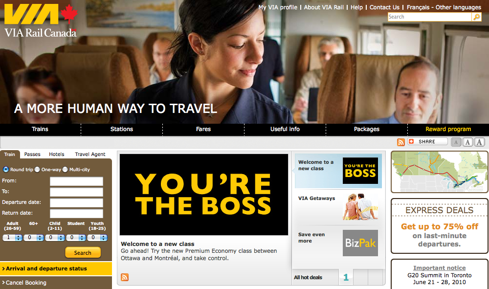 A VIA Rail Canada train attendant serves a passenger in a comfortable cabin with other travelers seated nearby.