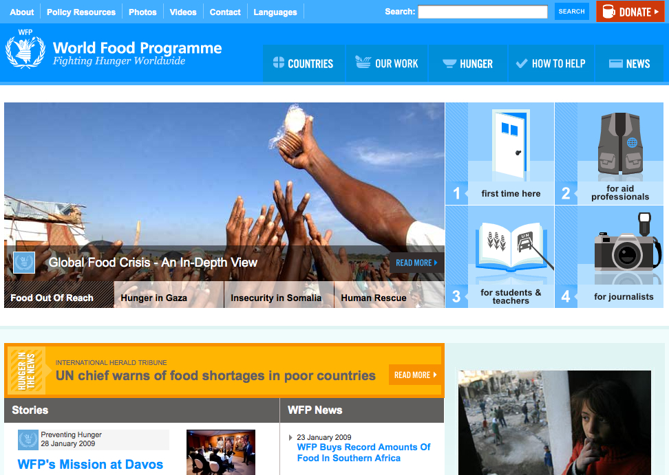 A person distributes bottled water to a crowd of raised hands, highlighting food and water scarcity issues.