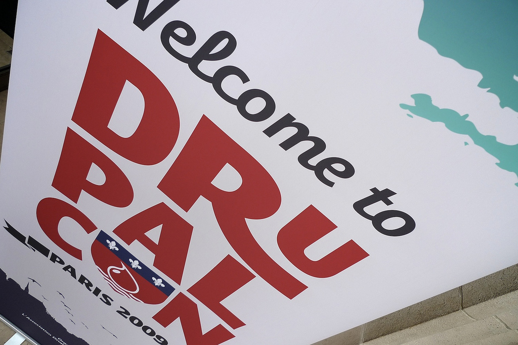 A large welcome sign for DrupalCon Paris 2009, featuring bold text and a partial map design.