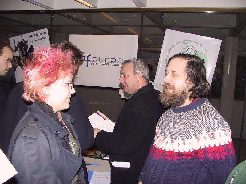 A group of people talking at a Free Software Foundation event, with one person wearing a patterned sweater.
