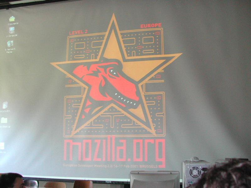 A large projector screen displays a Mozilla.