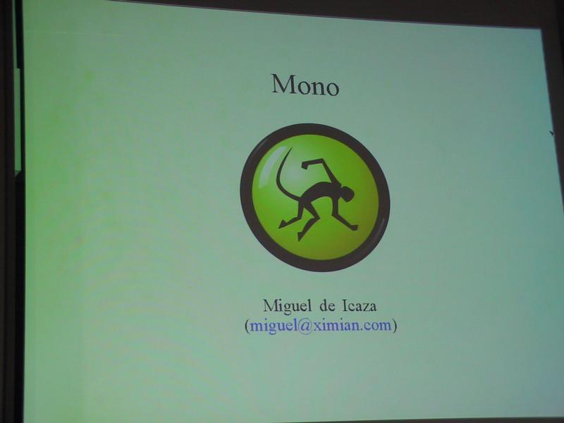 A presentation slide displays the Mono project logo, the name Miguel de Icaza, and an email address.