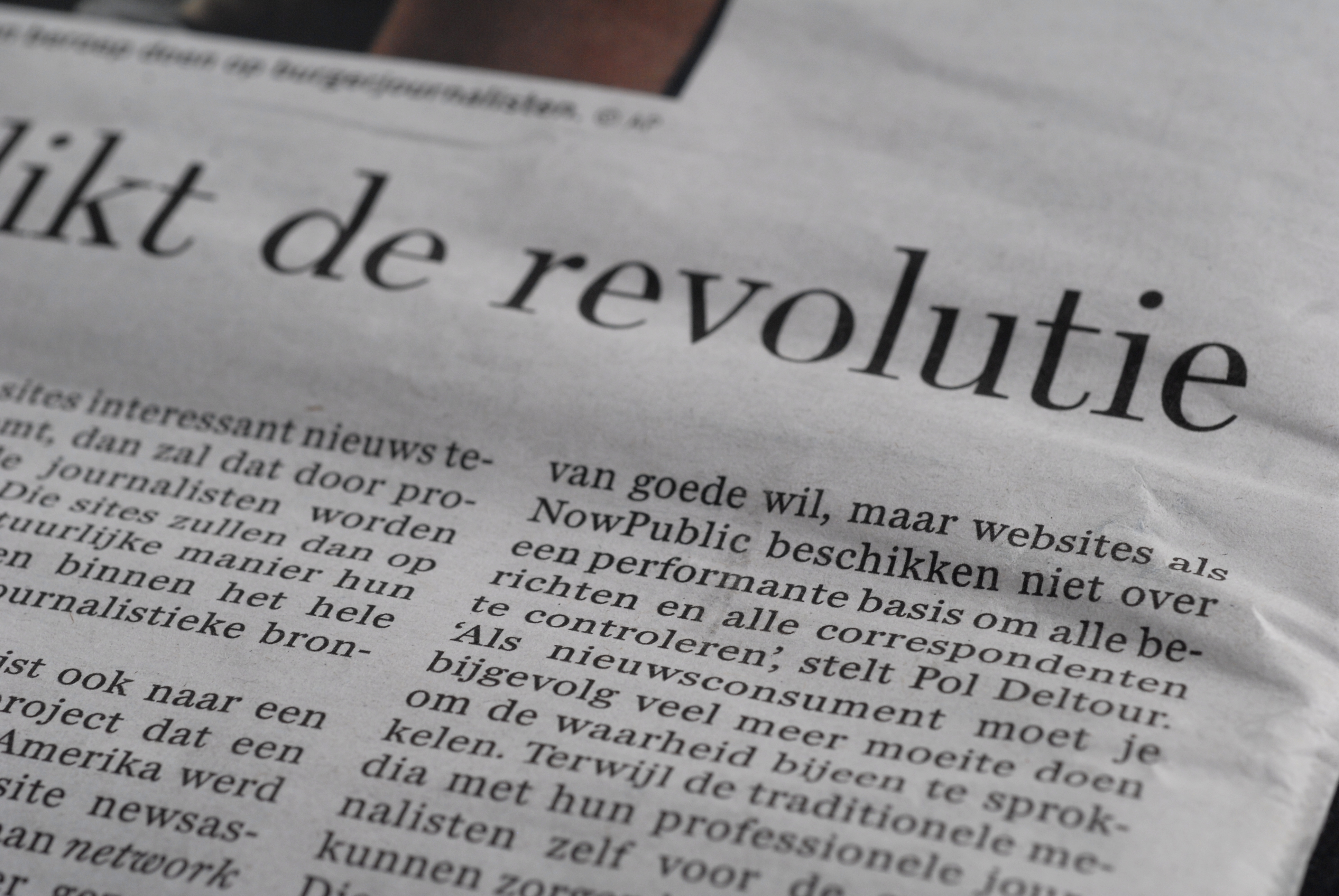 Close-up of a newspaper article discussing the credibility of citizen journalism compared to professional journalism.