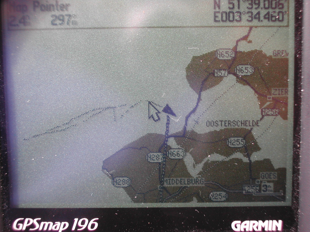 A GPS device displays a navigation map with coordinates and routes near Oosterschelde, Middelburg, and Goes.