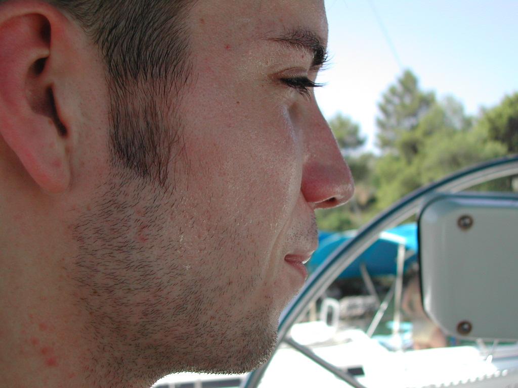Close-up of a man's face in profile, looking ahead.
