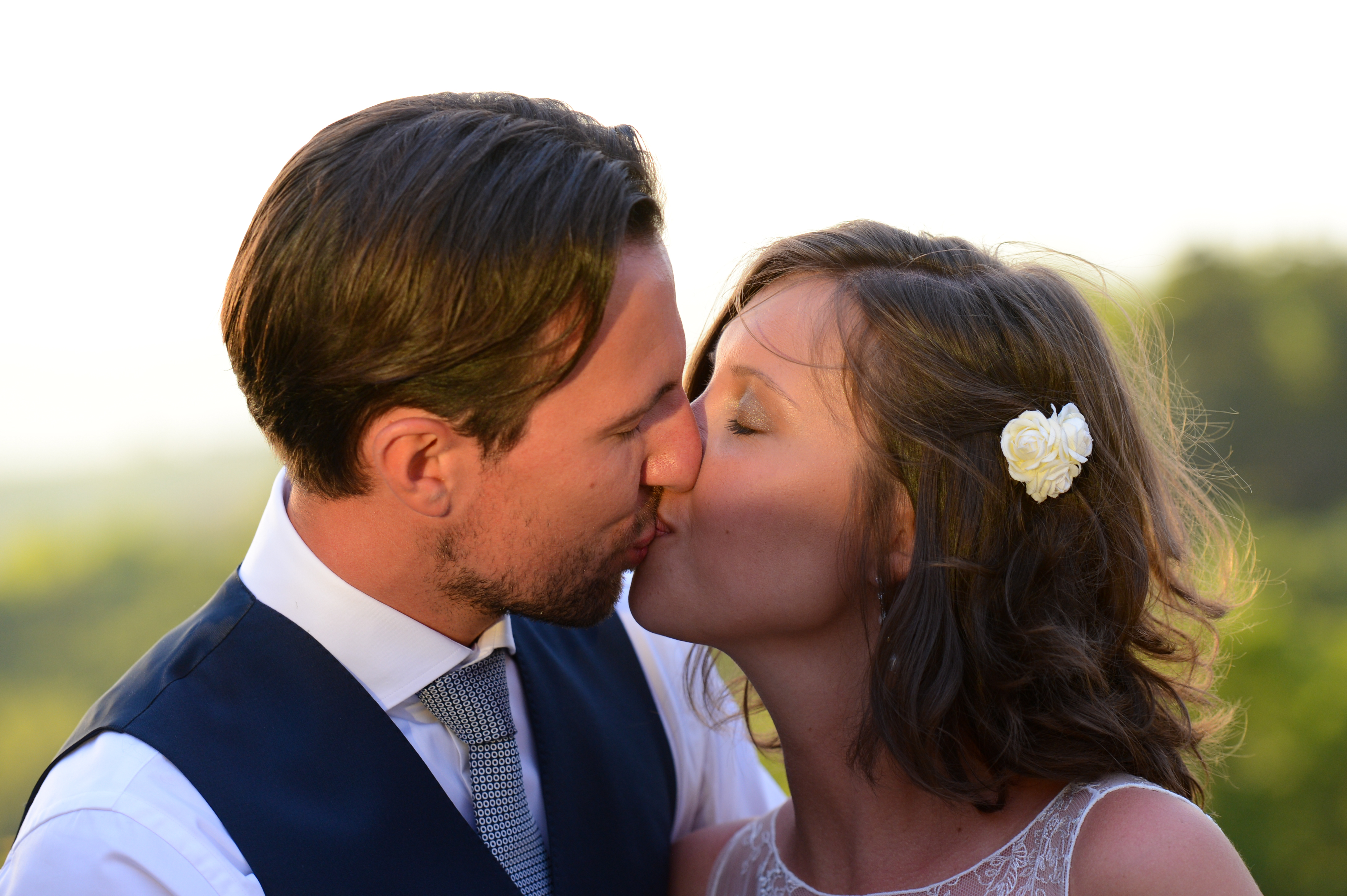 A bride and groom share a kiss on their wedding day.